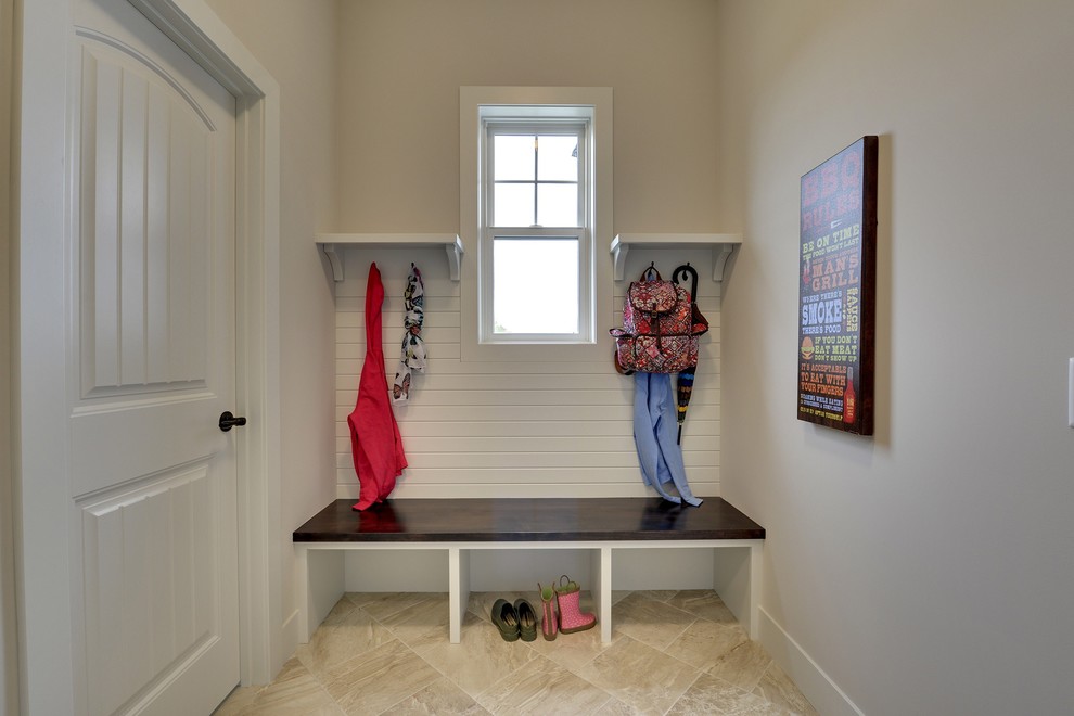 This is an example of a large traditional boot room in Minneapolis with beige walls, a single front door and a white front door.