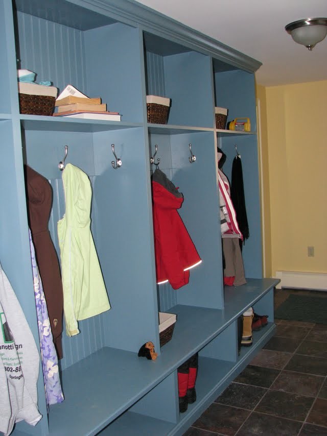 Elegant mudroom photo in Boston with yellow walls and a white front door