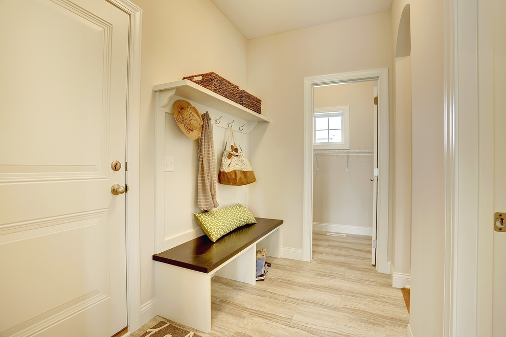 Large transitional light wood floor entryway photo in Minneapolis with beige walls and a white front door