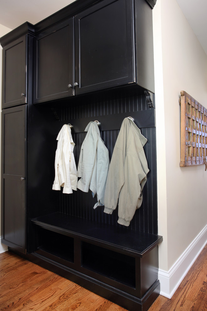 Mudroom - mid-sized traditional medium tone wood floor mudroom idea in Chicago with beige walls