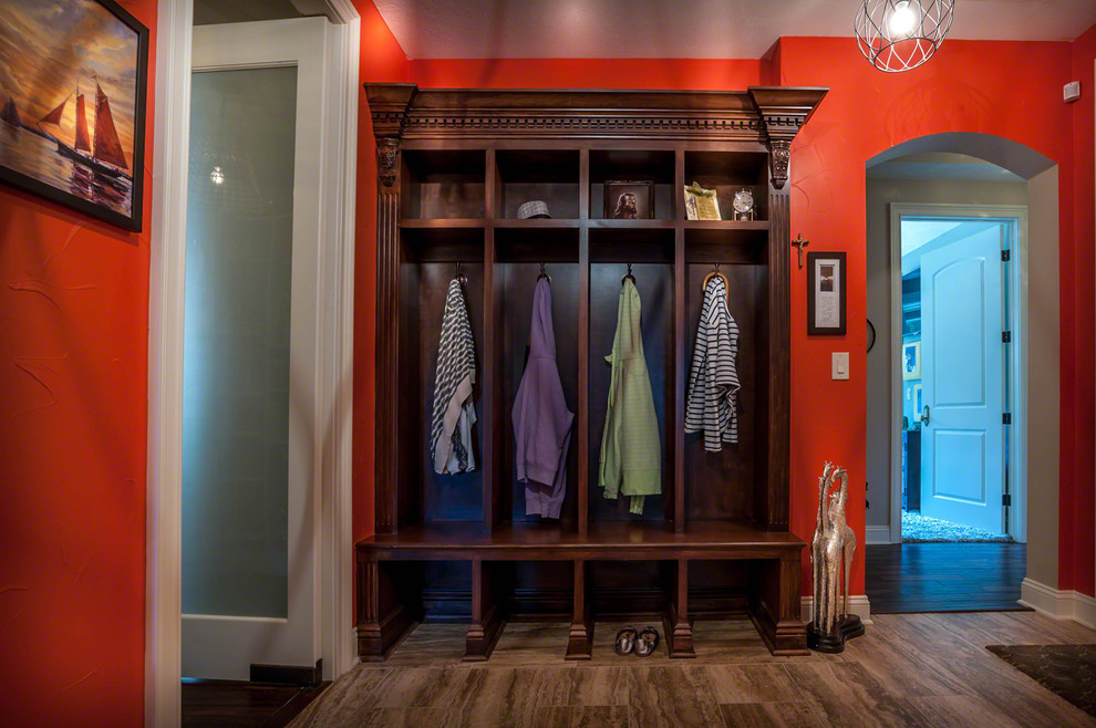 Large eclectic boot room in Cleveland with orange walls and ceramic flooring.