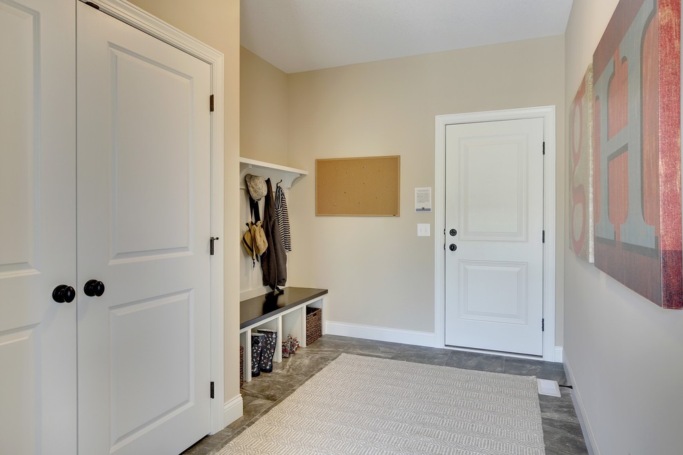 Inspiration for a large traditional boot room in Minneapolis with beige walls, a single front door and a white front door.