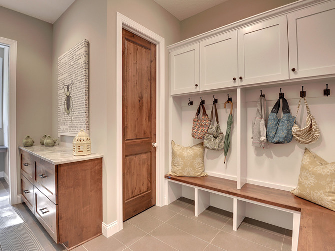 Large transitional porcelain tile entryway photo in Minneapolis with beige walls and a medium wood front door