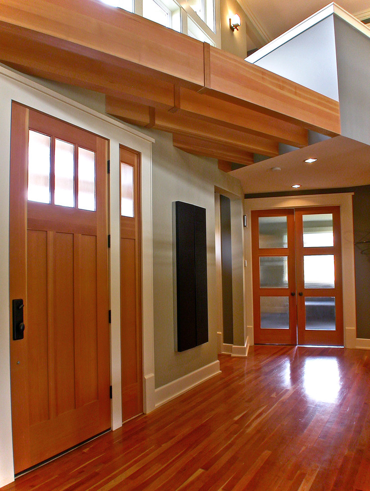 Example of a trendy single front door design in Seattle with a medium wood front door