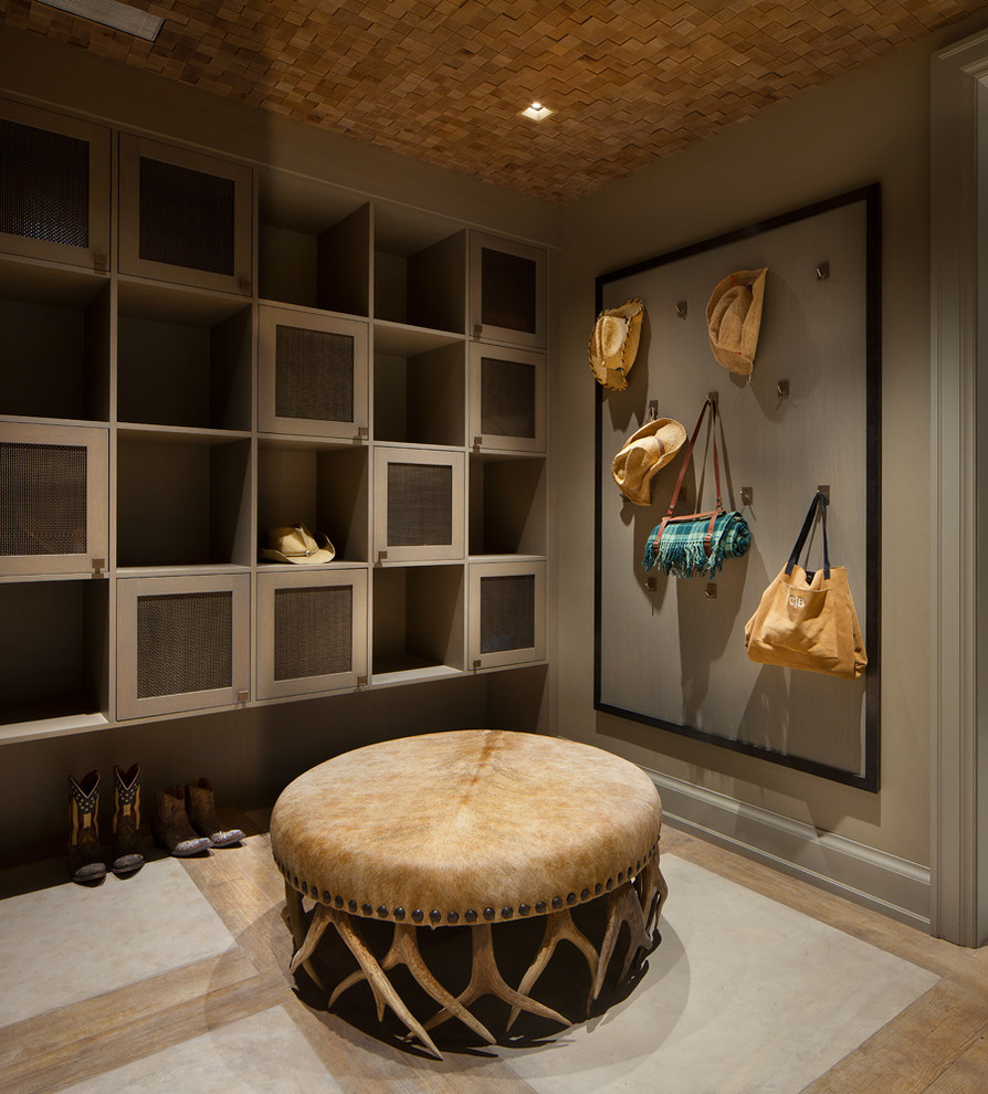 Example of a mountain style light wood floor mudroom design in Denver with beige walls