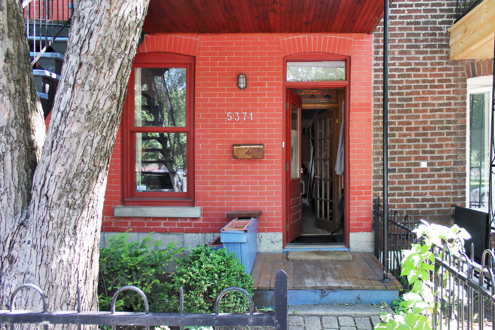 Entryway - eclectic entryway idea in Montreal with a red front door