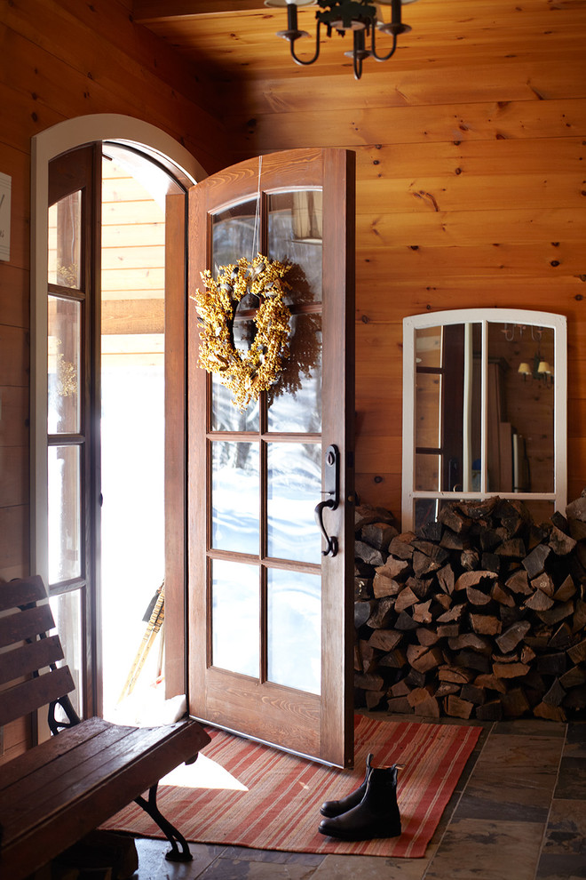 Inspiration for a rustic boot room in Dallas with a single front door and a medium wood front door.