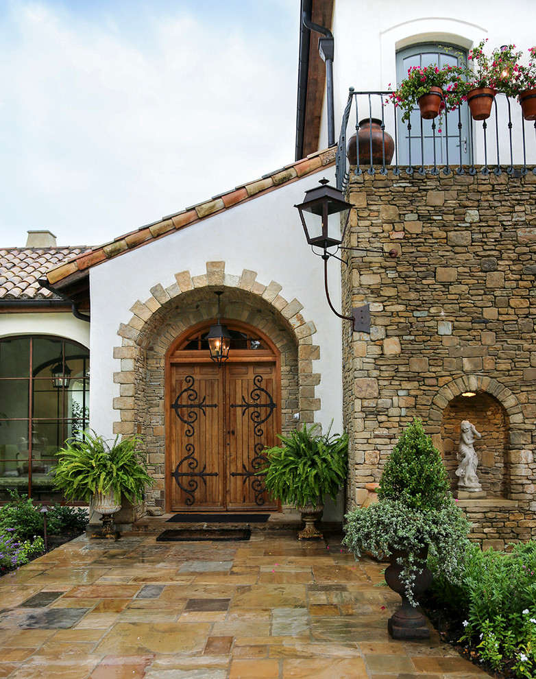 Inspiration for a mediterranean entrance with a double front door and a medium wood front door.