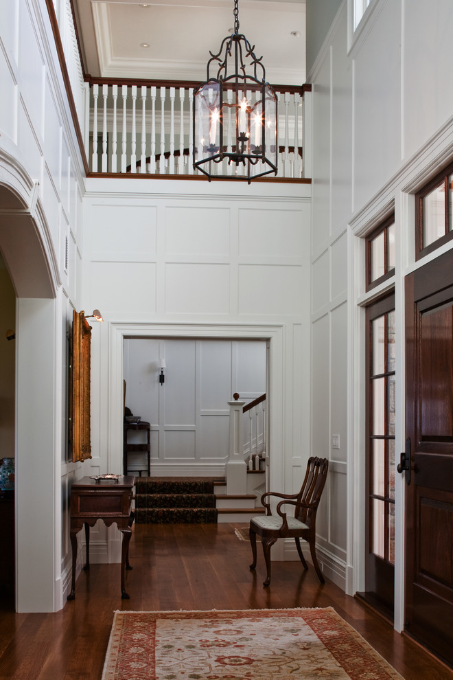 Large classic foyer in Providence with white walls, medium hardwood flooring, a single front door and a dark wood front door.