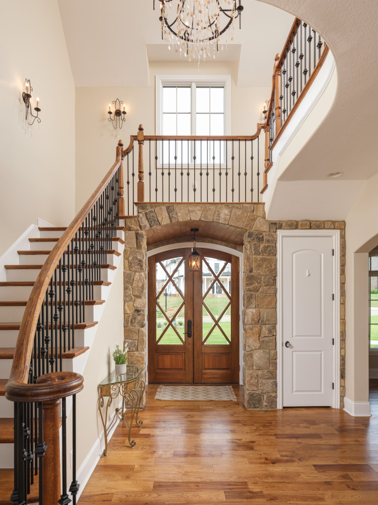 Photo of an entrance in Other with beige walls, medium hardwood flooring, a double front door, a glass front door and brown floors.