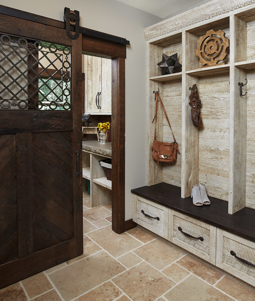 Photo of a rustic boot room in Grand Rapids with beige floors.
