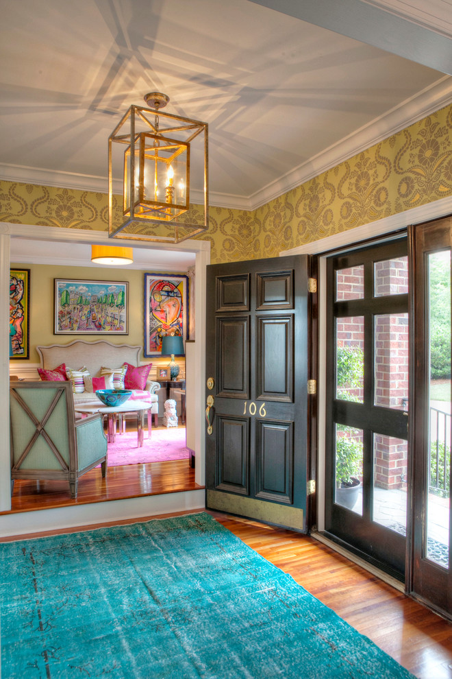 Mid-sized trendy medium tone wood floor entryway photo in Other with multicolored walls and a dark wood front door