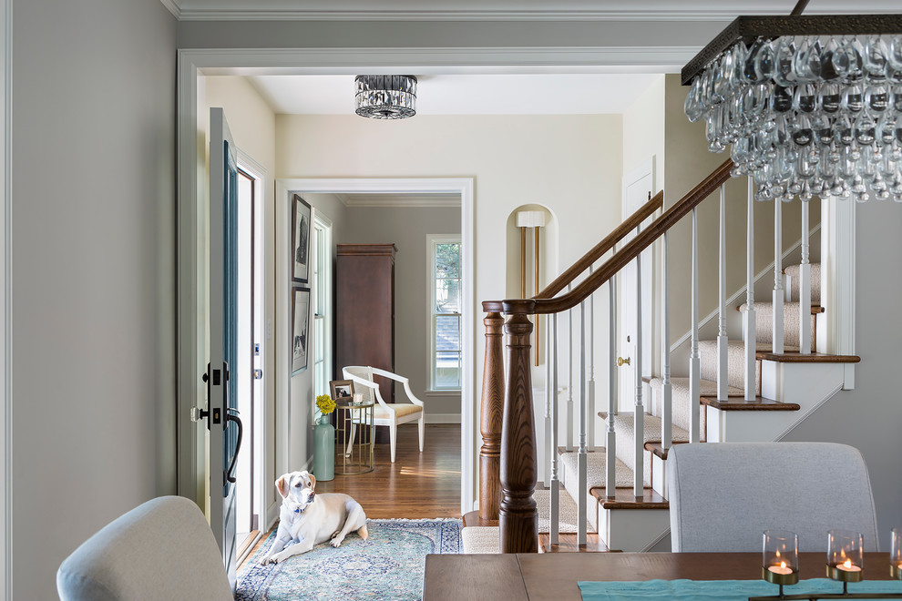 Mid-sized transitional medium tone wood floor entryway photo in Minneapolis with white walls and a white front door