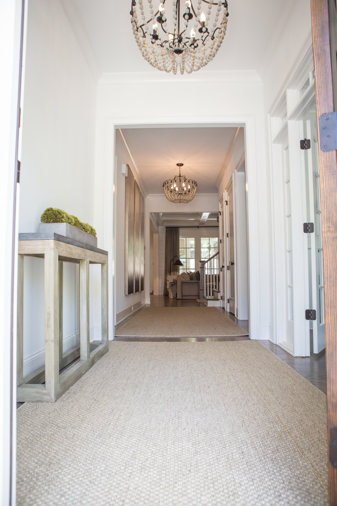 Large elegant medium tone wood floor and brown floor entryway photo in Atlanta with white walls and a medium wood front door
