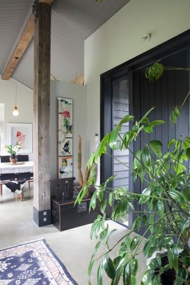 Kleine Eklektische Haustür mit grauer Wandfarbe, Betonboden, Einzeltür und schwarzer Haustür in Sonstige