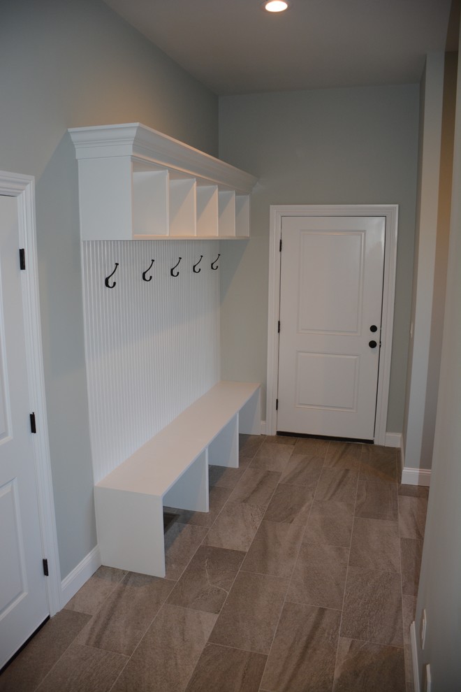 Mudroom - mid-sized traditional mudroom idea in Other with gray walls
