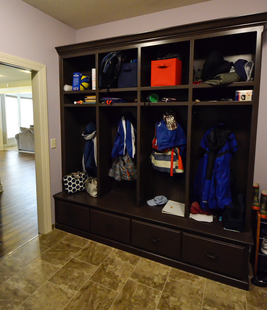 This is an example of a large traditional boot room in Kansas City with purple walls and ceramic flooring.