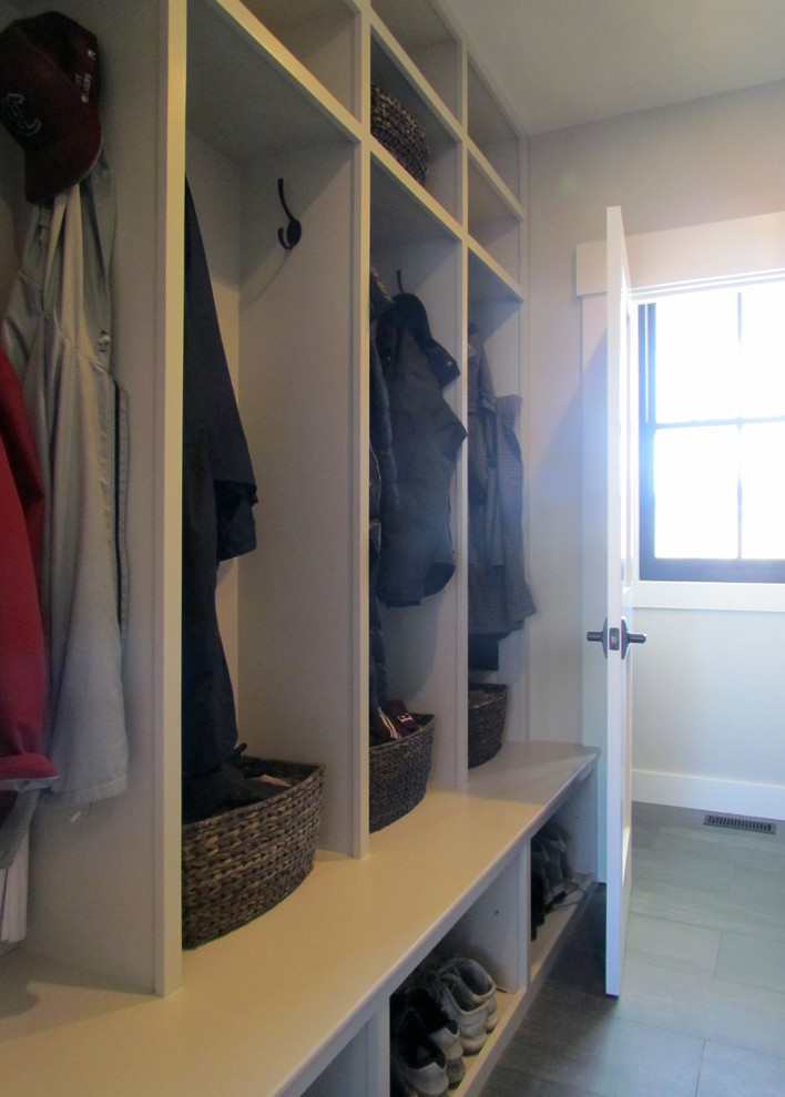 Design ideas for a small traditional boot room in Portland Maine with white walls and ceramic flooring.