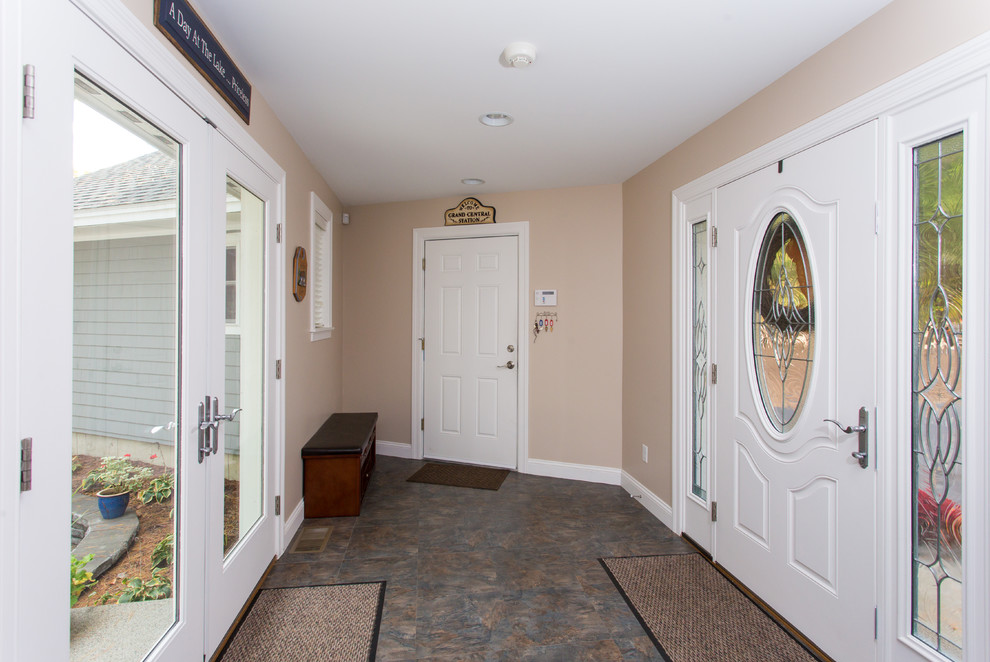 Modelo de hall tradicional de tamaño medio con paredes beige, suelo de baldosas de porcelana, puerta simple y puerta blanca