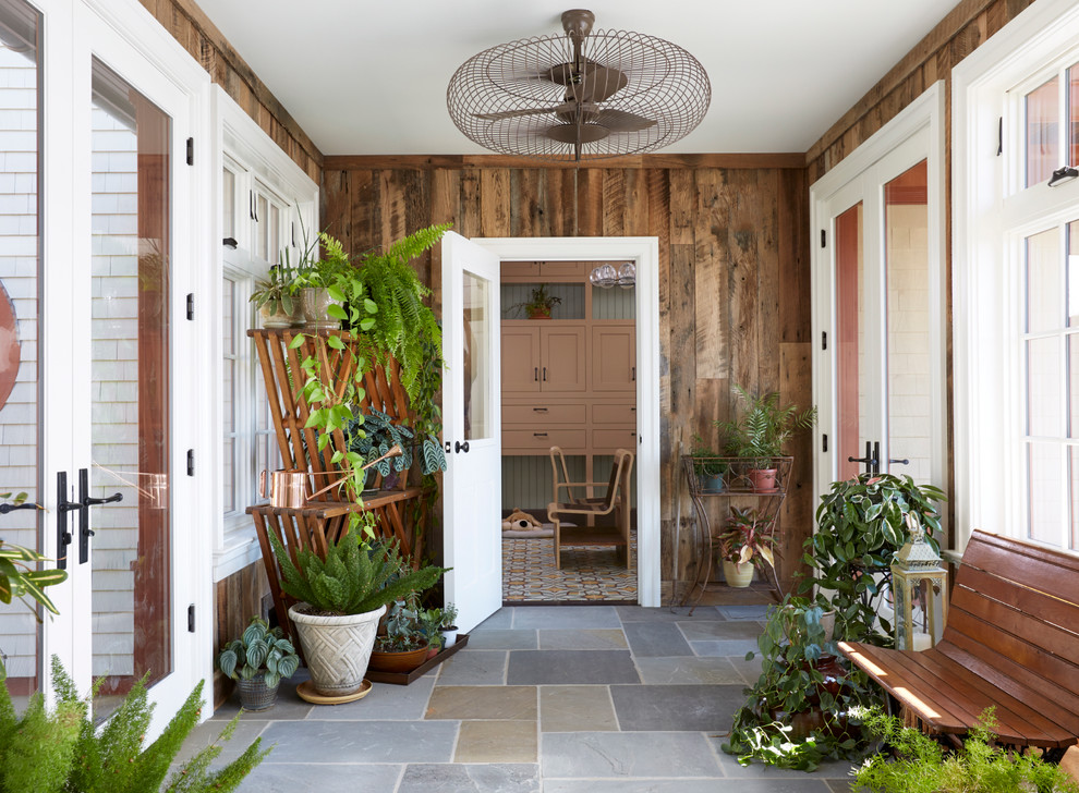 This is an example of a medium sized farmhouse vestibule in New York with a single front door, a white front door, slate flooring and multi-coloured floors.