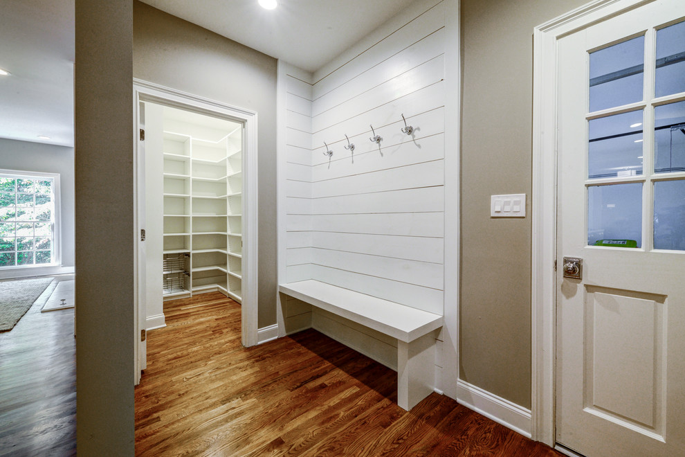Mittelgroßer Klassischer Eingang mit Stauraum, beiger Wandfarbe, braunem Holzboden, Einzeltür, weißer Haustür und braunem Boden in Atlanta