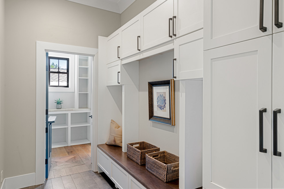 This is an example of a medium sized farmhouse boot room in San Francisco with ceramic flooring, a stable front door and grey floors.