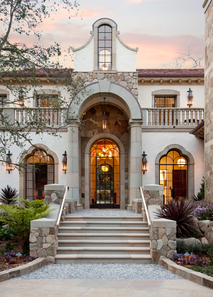 Inspiration for a mediterranean entrance in Santa Barbara with a glass front door.