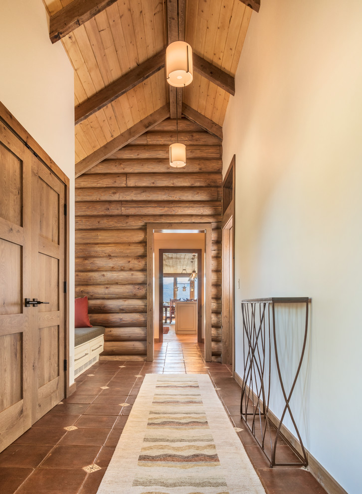 Photo of a medium sized rustic foyer in Denver with beige walls, ceramic flooring, a double front door, a medium wood front door and brown floors.