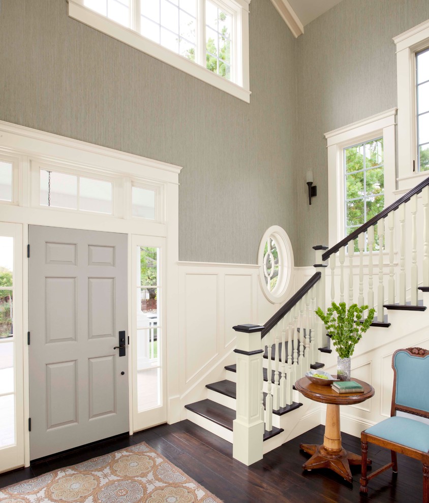This is an example of a large traditional foyer in Charlotte with grey walls, dark hardwood flooring, a single front door and a grey front door.