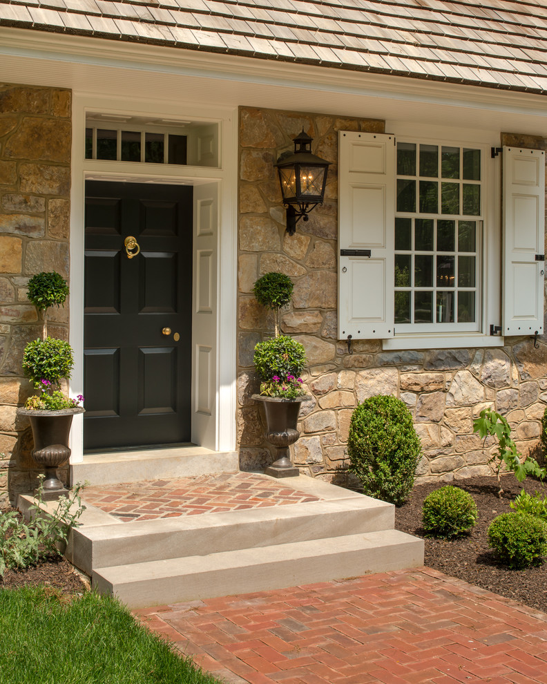 Example of a mid-sized classic entryway design in Philadelphia with a black front door