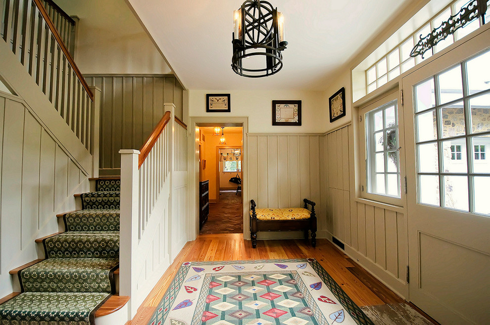Inspiration for a classic foyer in Philadelphia with beige walls, medium hardwood flooring and a glass front door.