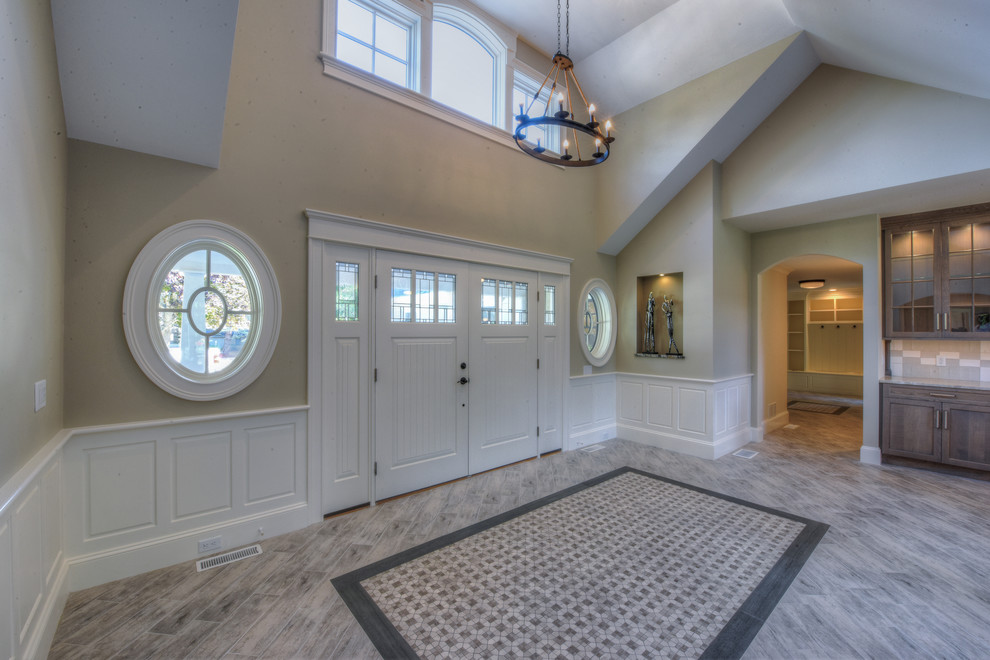 Entryway - large traditional marble floor entryway idea in Boston with beige walls and a white front door