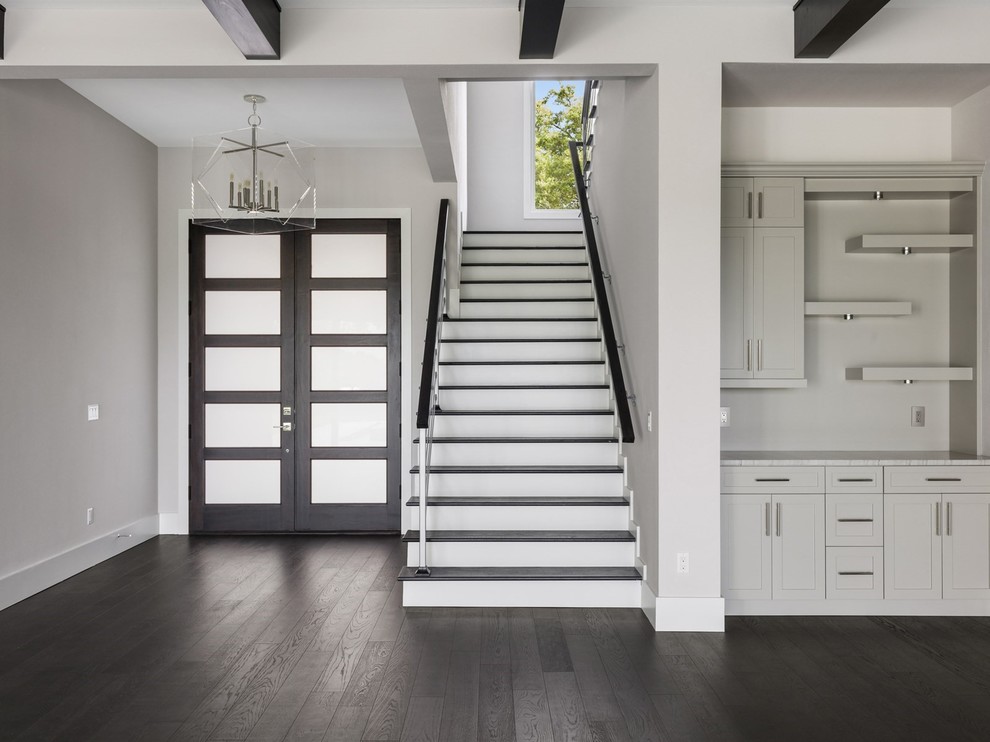 Entryway - large transitional dark wood floor and black floor entryway idea in Orlando with gray walls and a dark wood front door