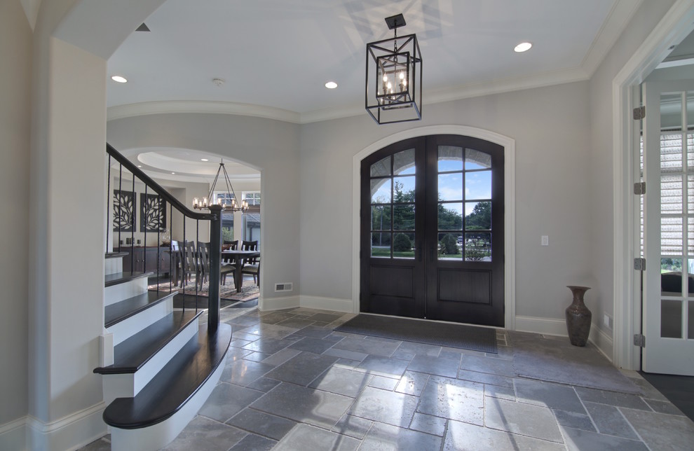 Entryway - large traditional slate floor entryway idea in Chicago with gray walls and a dark wood front door
