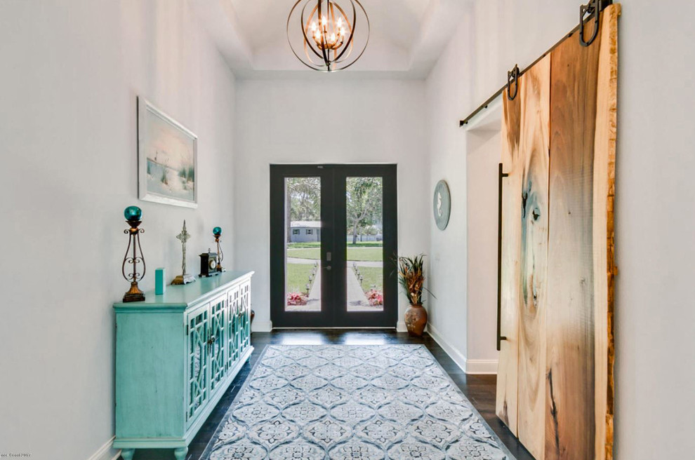 Inspiration for a mid-sized transitional dark wood floor and brown floor entryway remodel in Orlando with gray walls and a glass front door