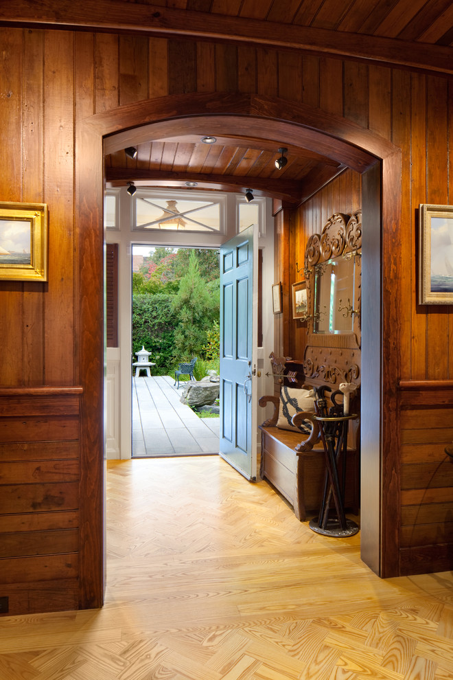 Example of a large eclectic light wood floor vestibule design in Providence with brown walls