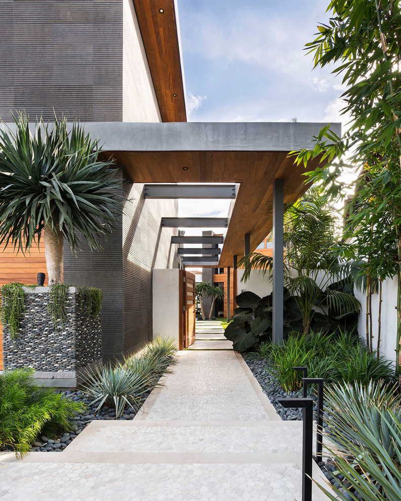 Photo of a contemporary entrance in Orange County with grey walls and beige floors.