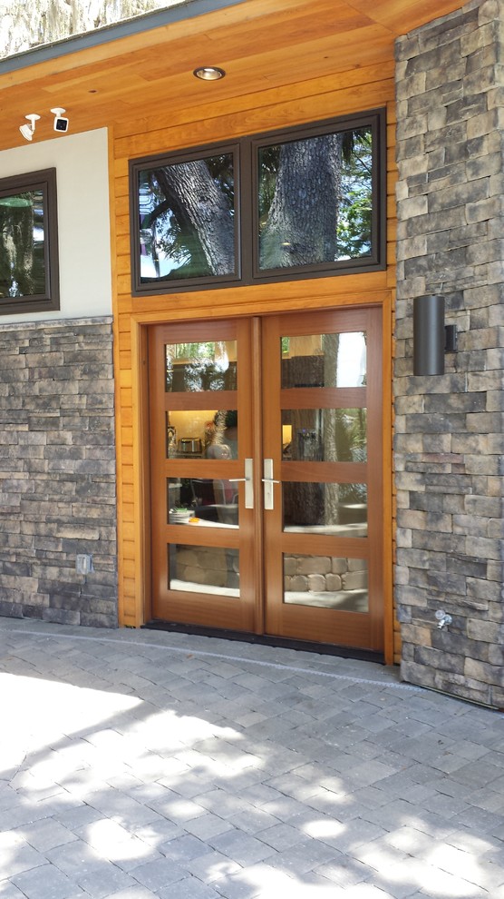 Ejemplo de entrada minimalista con puerta doble y puerta de madera en tonos medios