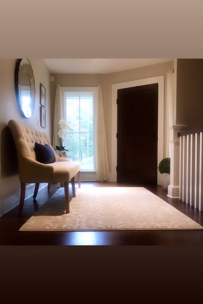 Geräumiges Klassisches Foyer mit beiger Wandfarbe, braunem Holzboden, braunem Boden, Einzeltür, dunkler Holzhaustür und eingelassener Decke in Sonstige