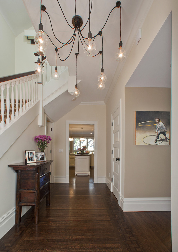 Trendy dark wood floor foyer photo in Tel Aviv with beige walls