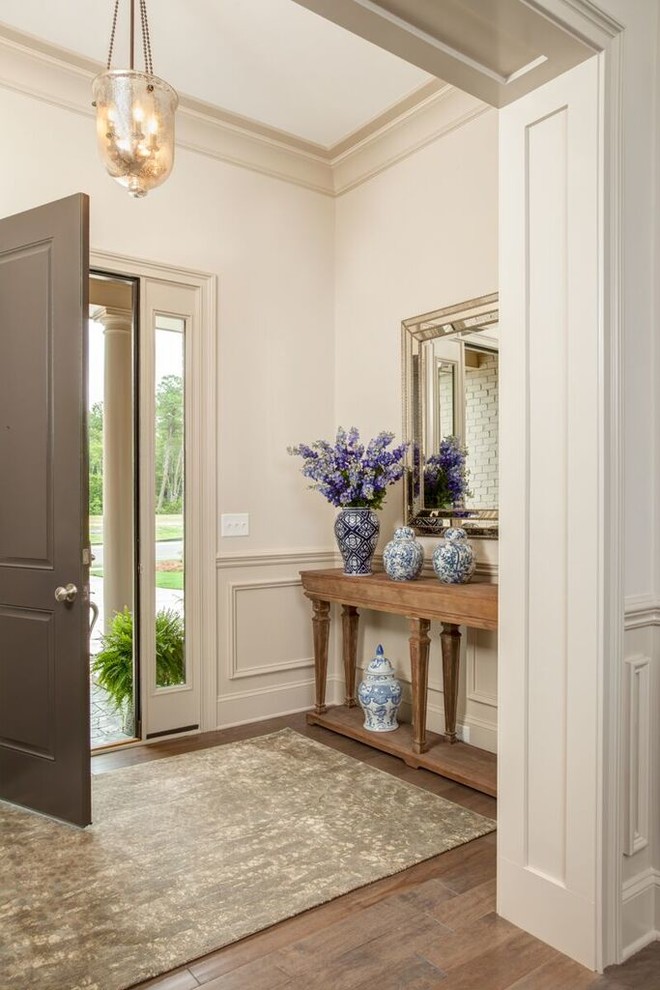 Medium sized traditional foyer in Wilmington with beige walls, a single front door, a grey front door, medium hardwood flooring and feature lighting.