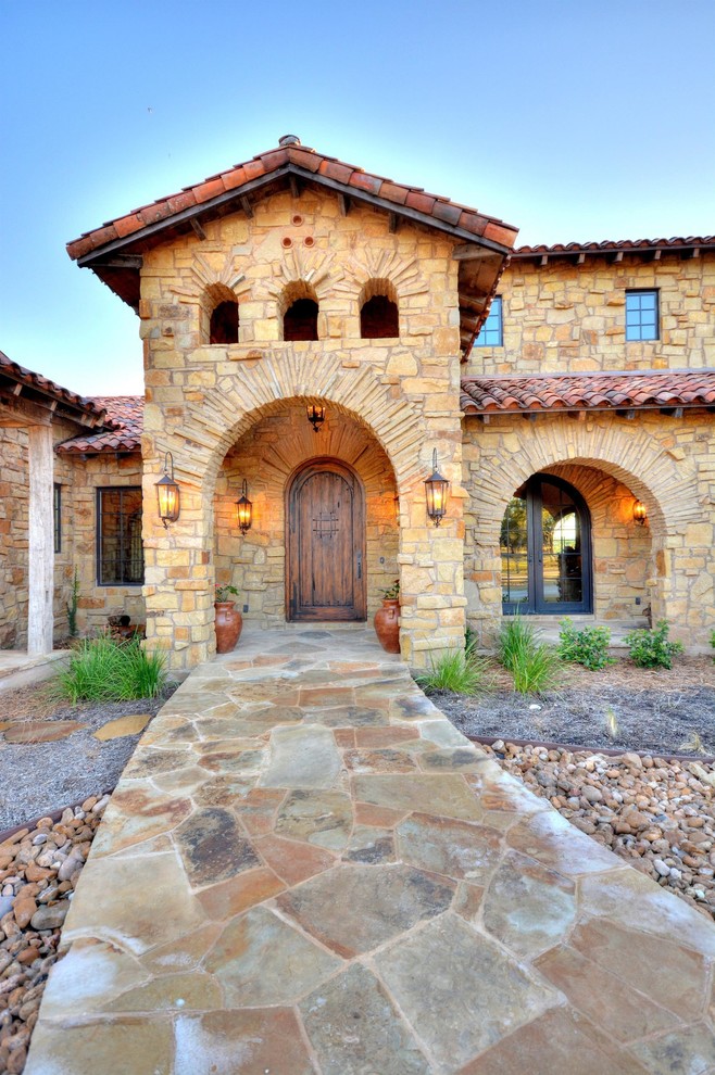 Inspiration for a mediterranean entrance in Austin with a single front door and a medium wood front door.