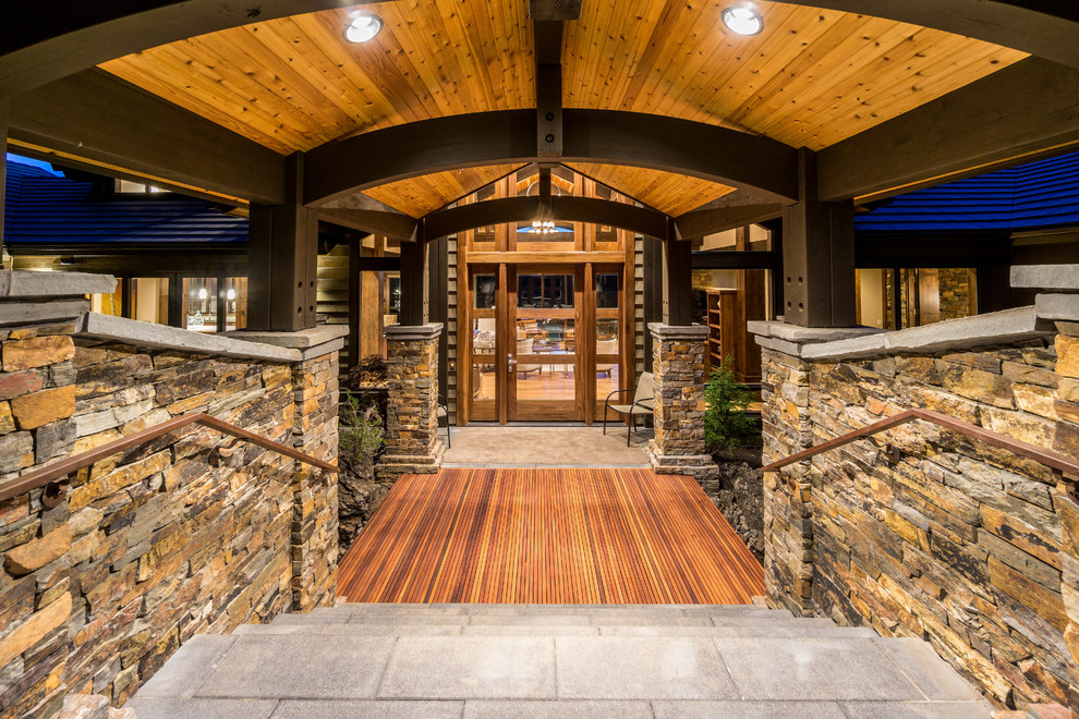 Large mountain style medium tone wood floor entryway photo in Other with a glass front door