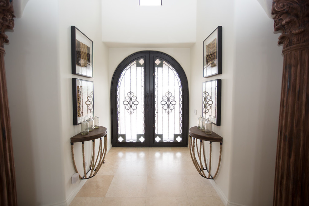 Inspiration for a huge eclectic travertine floor entryway remodel in Phoenix with white walls and a metal front door