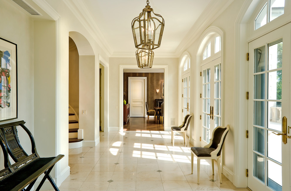 Design ideas for a traditional foyer in Chicago with beige walls, a double front door and a glass front door.