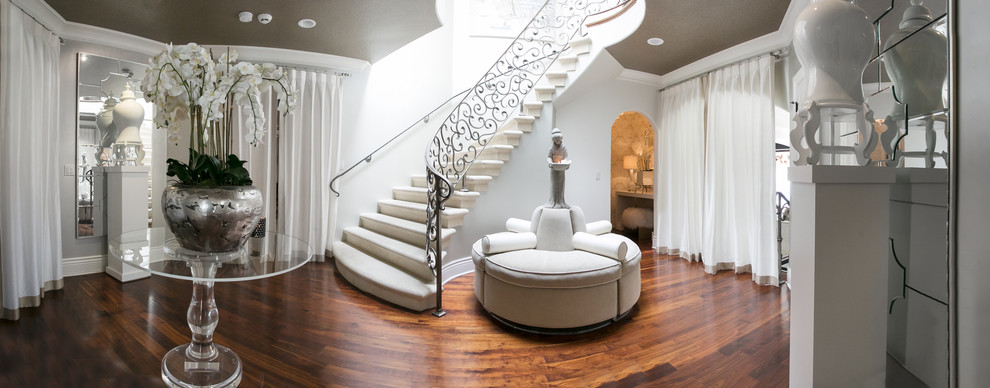 Example of a large transitional medium tone wood floor and brown floor foyer design in Other with white walls