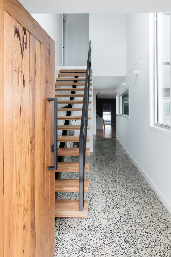Entryway - mid-sized modern cork floor and gray floor entryway idea in Canberra - Queanbeyan with white walls and a medium wood front door