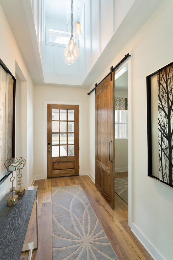 Design ideas for a medium sized classic foyer in Austin with white walls, a single front door and a medium wood front door.