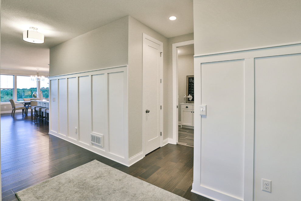 Inspiration for a large contemporary medium tone wood floor foyer remodel in Minneapolis with gray walls