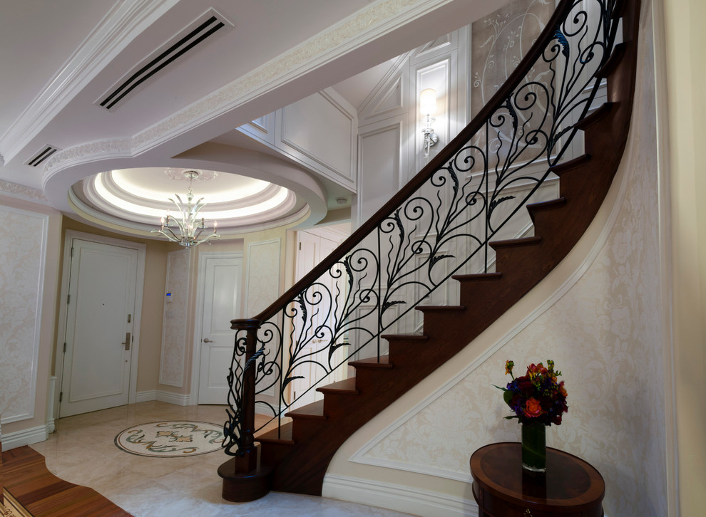 Idée de décoration pour une grande entrée tradition avec un mur beige, un sol en marbre, une porte pivot et une porte blanche.